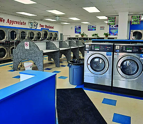 Inside My Laundromat: washers, folding tables and blue counters